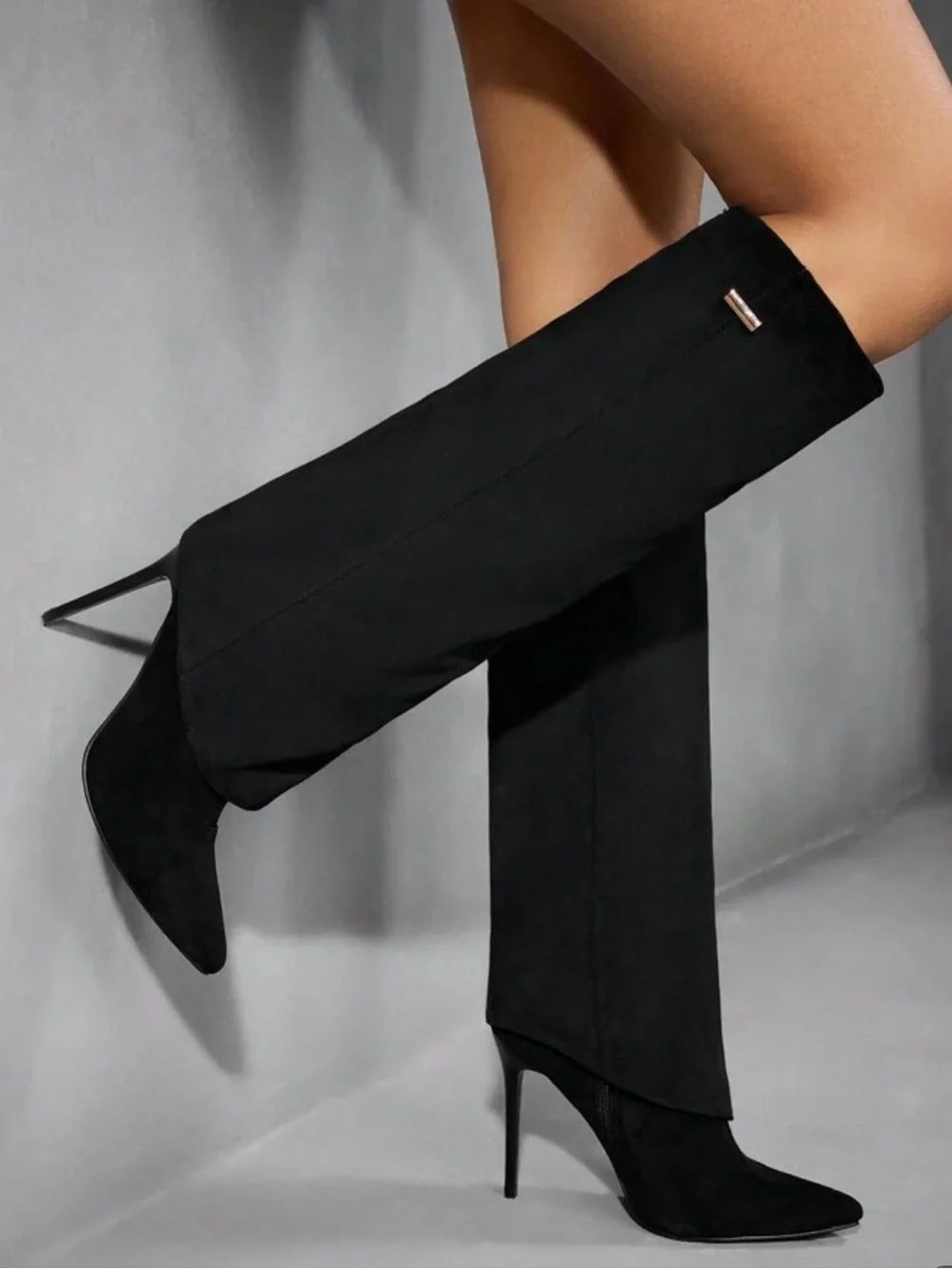 Black suede boots with pointed toe and stiletto heel